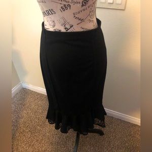 Classic hi-lo pencil skirt with ruffled hem.